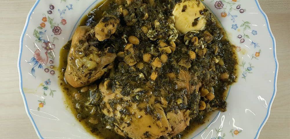 Ghormeh Sabzi with chicken simmering in a pot, becoming rich